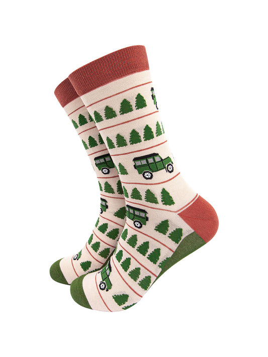 cream socks with a burnt orange cuff and heel with a green toe and sole and a pattern of green trees and jeep vehicles