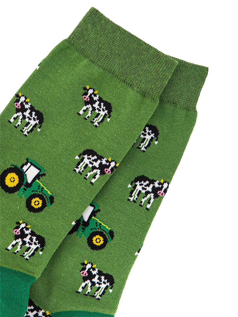 close up of the green tractors and black and white cow pattern on the bamboo socks