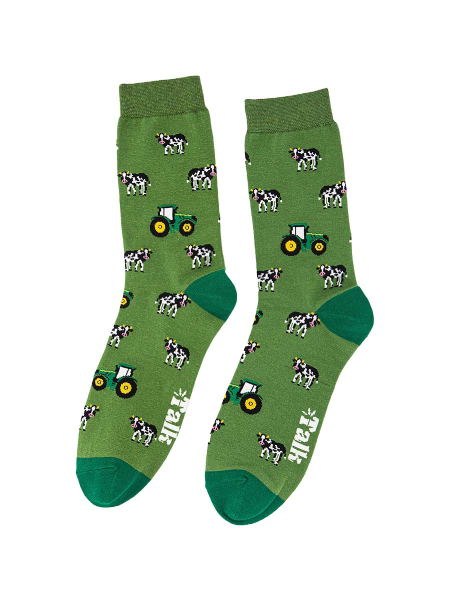green novelty socks featuring a pattern of cows and tractors