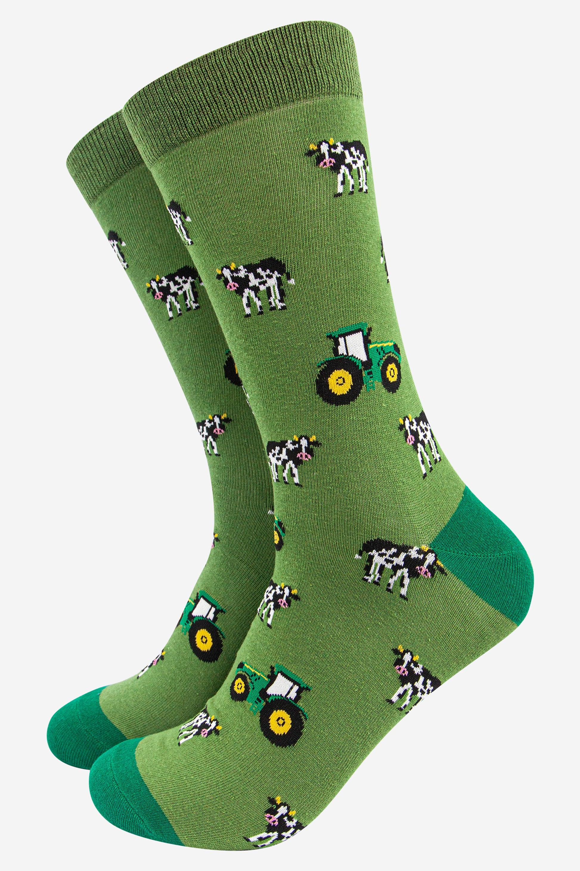 green bamboo socks with an all over green tractor and black and white cows