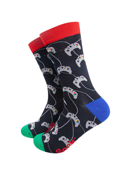black socks with an all over pattern of grey game controllers with red cuff, blue heel and green toe