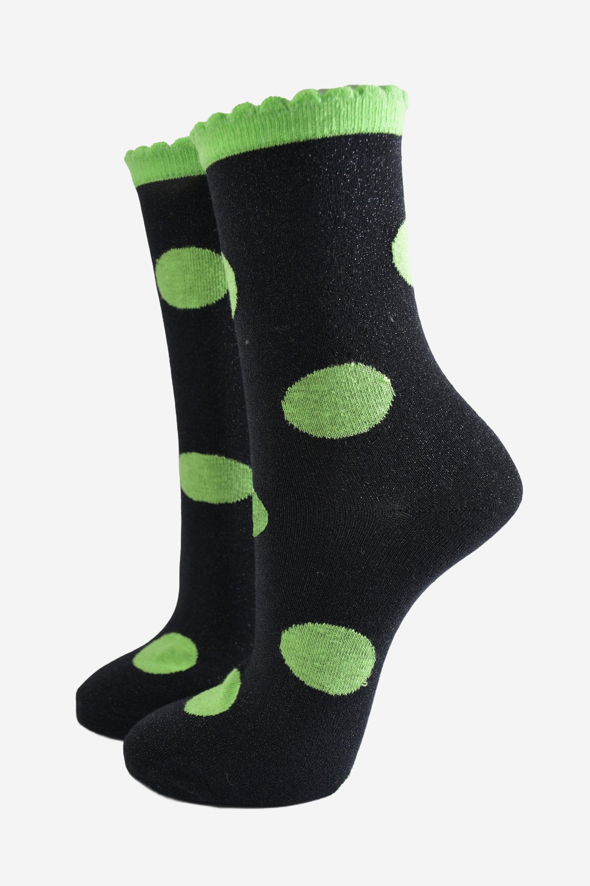 black socks with a large lime green polka dot pattern and scalloped cuff