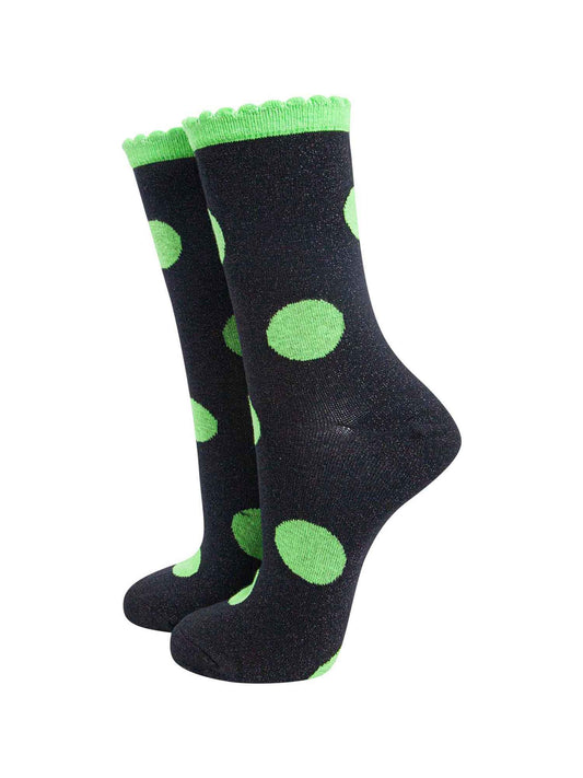 black socks with a large lime green polka dot pattern and scalloped cuff