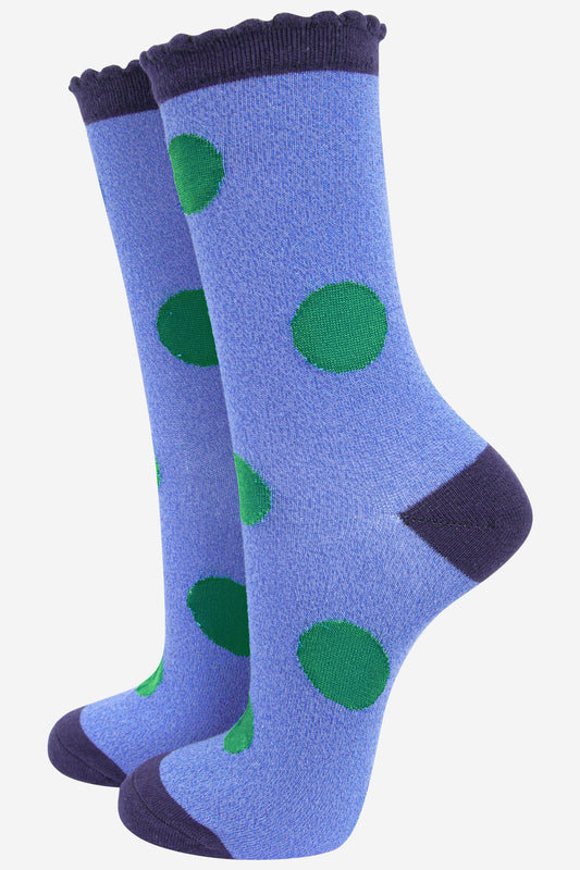 denim blue socks with a navy blue heel, toe and cuff with an all over green polka dot pattern and scalloped cuff