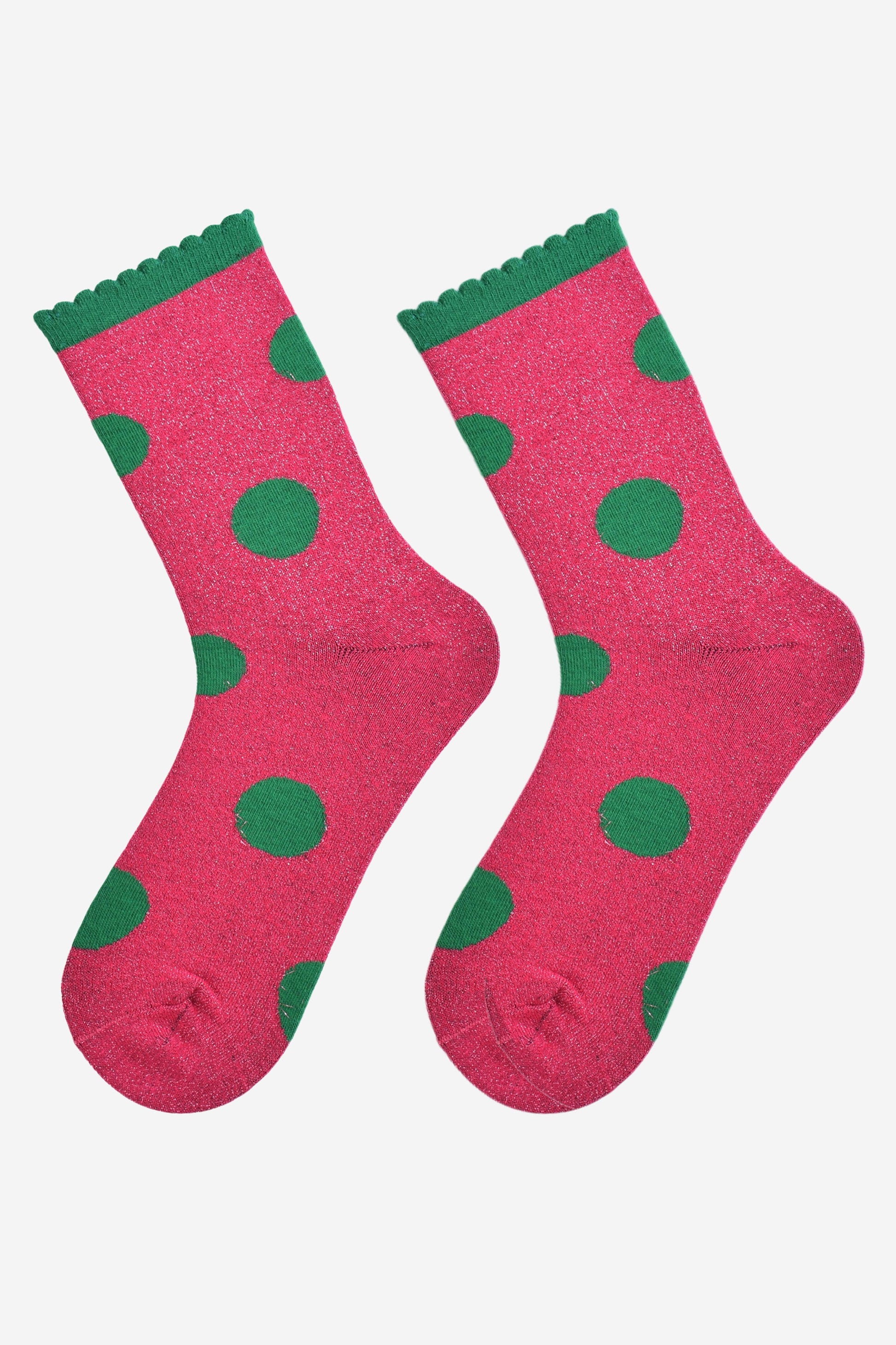  hot pink and green large polka dot pattern glitter socks laying flat, showing the all over glitter sparkle