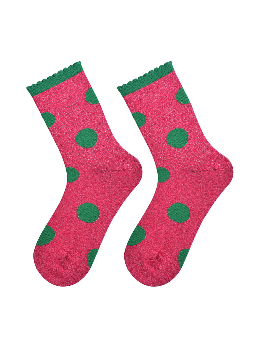 hot pink and green large polka dot pattern glitter socks laying flat, showing the all over glitter sparkle