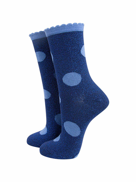 navy blue socks with a large light blue polka dot pattern and scalloped cuff