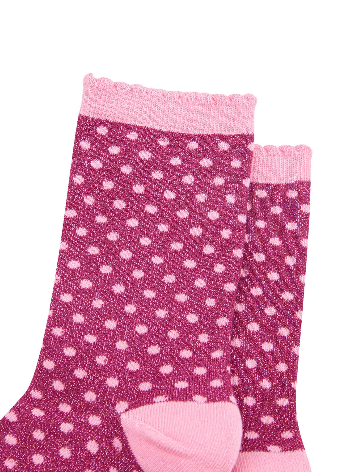 close up of the small polka dot print pattern and all over silver sparkle on the ankle socks