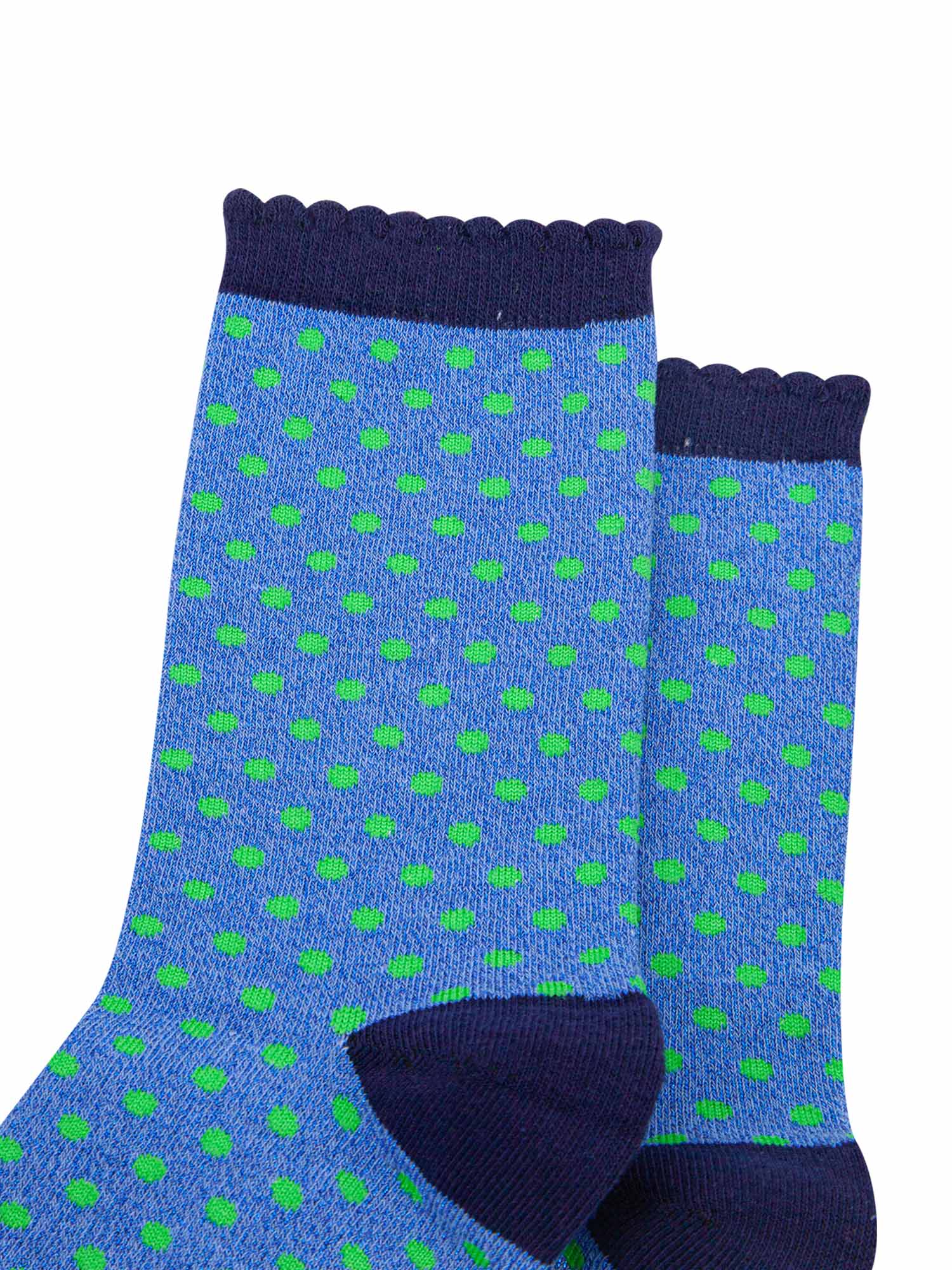 close up of the green spotted pattern and all over sparkly material of the ankle socks
