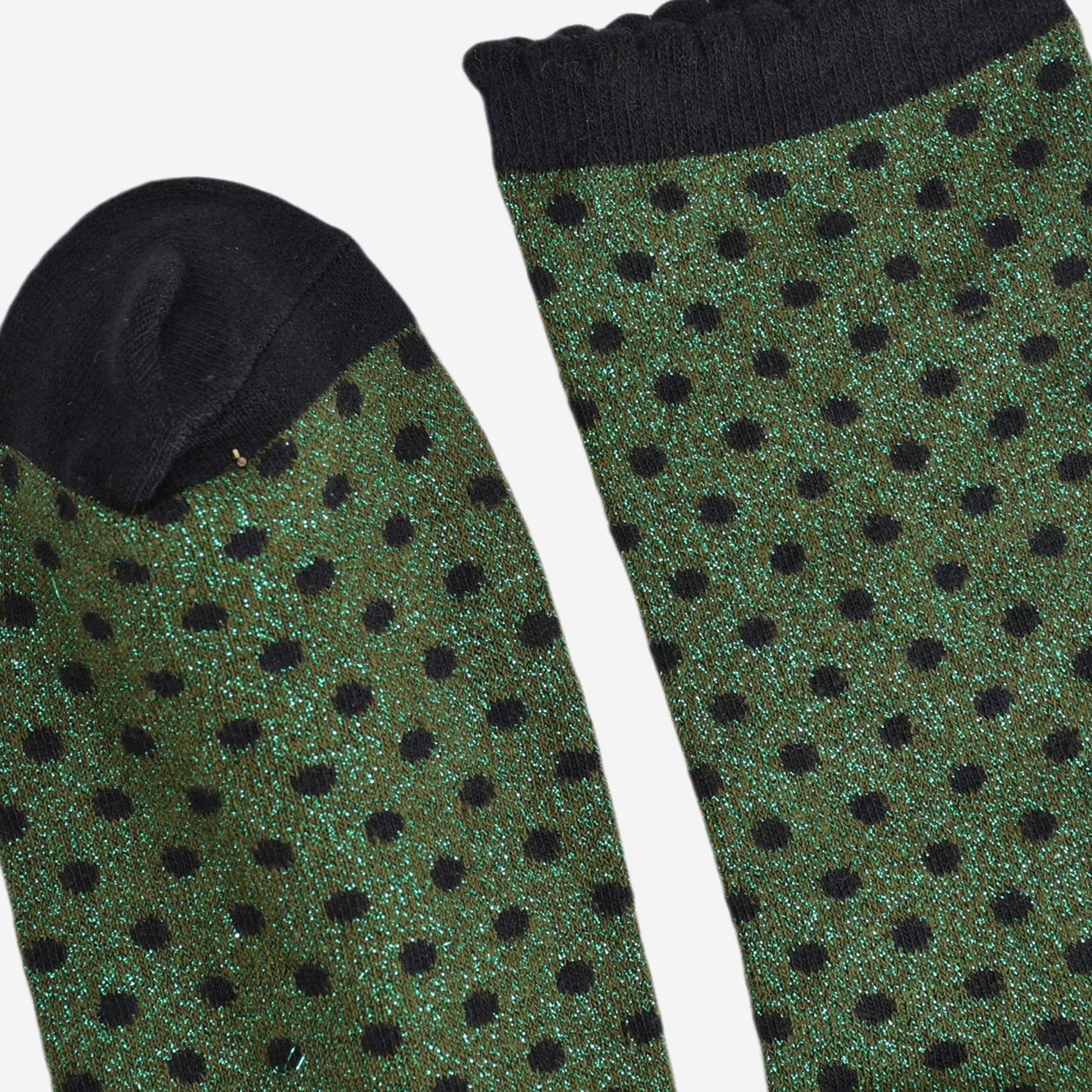 close up of the cuff and toe of the socks, they are both black and the cuff is scalloped