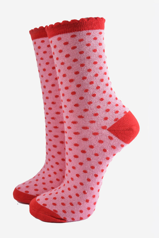 light pink ankle socks with an all over pattern of small red polka dots