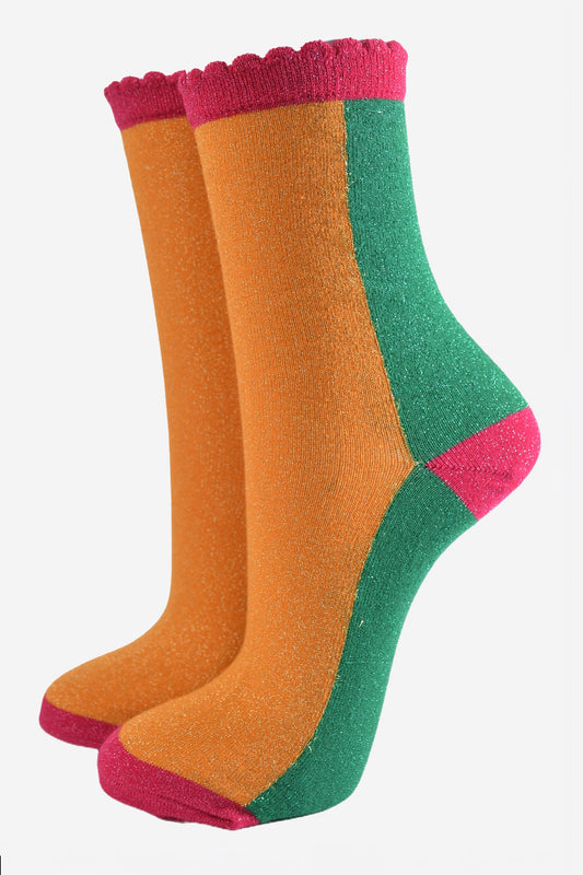 orange and green colour block socks with pink heel, toe and cuff with an all over glitter sparkle and scalloped edge