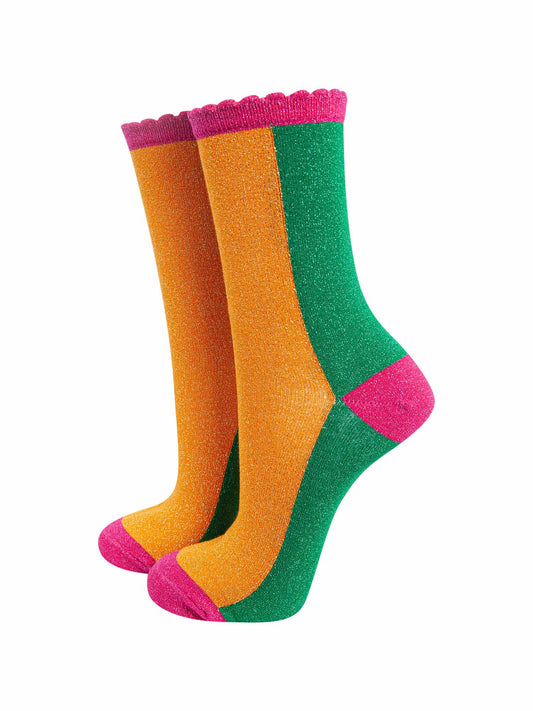 orange and green colour block socks with pink heel, toe and cuff with an all over glitter sparkle and scalloped edge