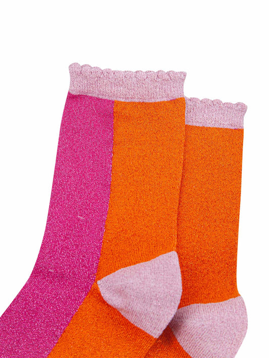 close up of the sparkly material and pink scalloped top on these ladies cotton socks