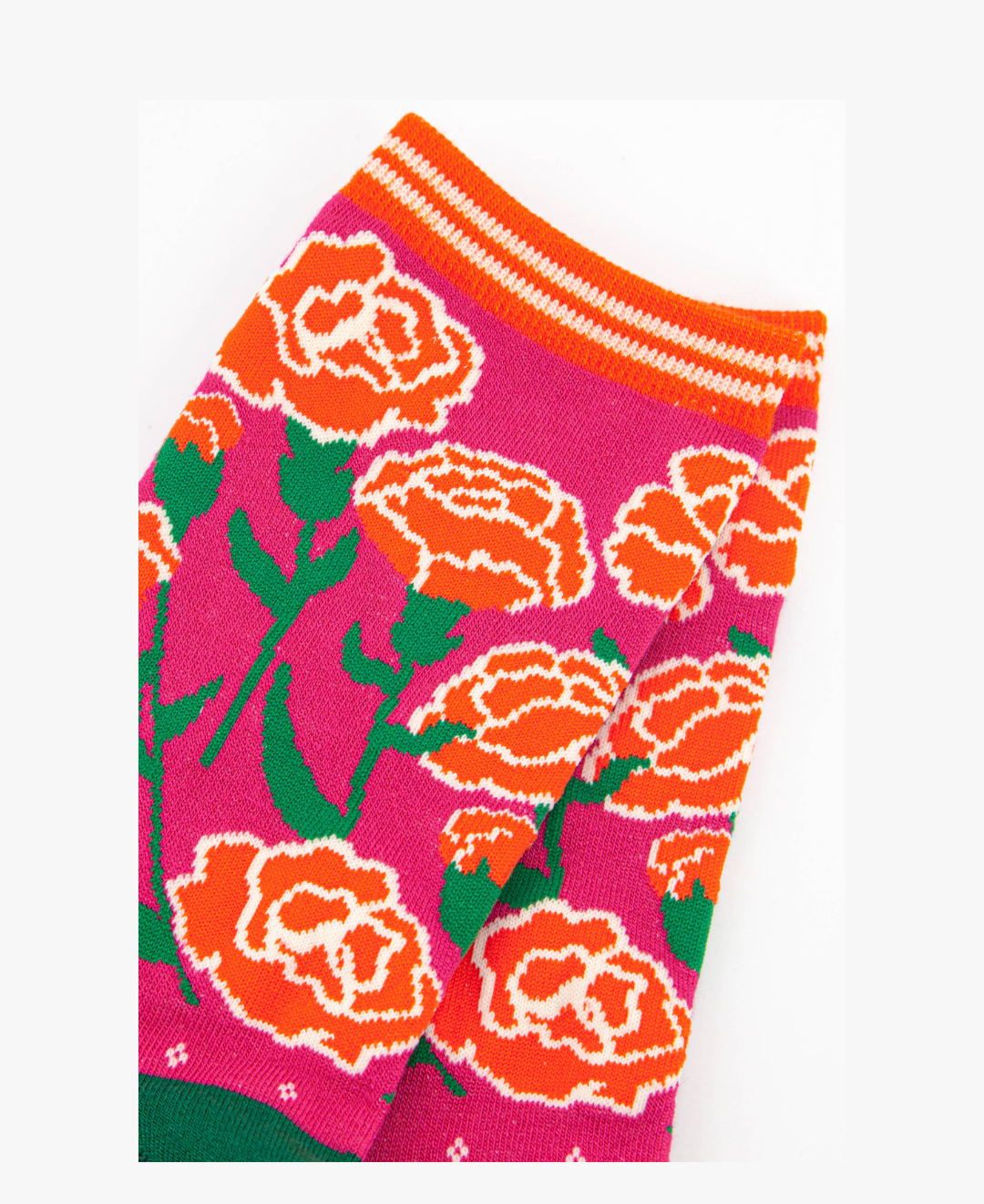 close up of the carnation floral design on the ankle of the socks