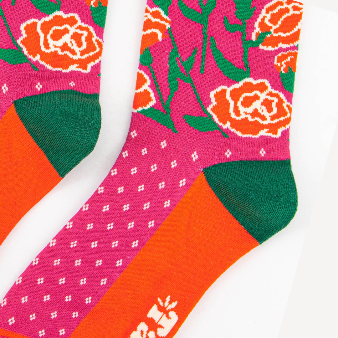 close up of the carnation floral design on the ankle of the socks