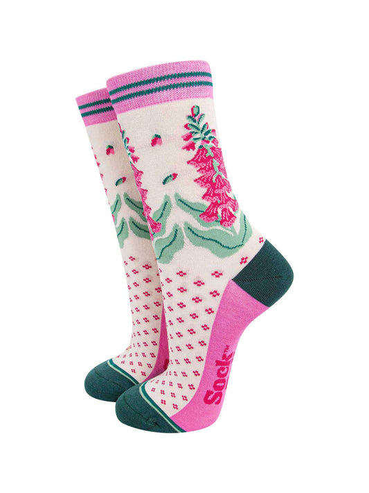 cream bamboo socks with a dark green heel and toe and light pink sole. the ankle of the socks is covered with fuchsia pink and green foxgloves.
