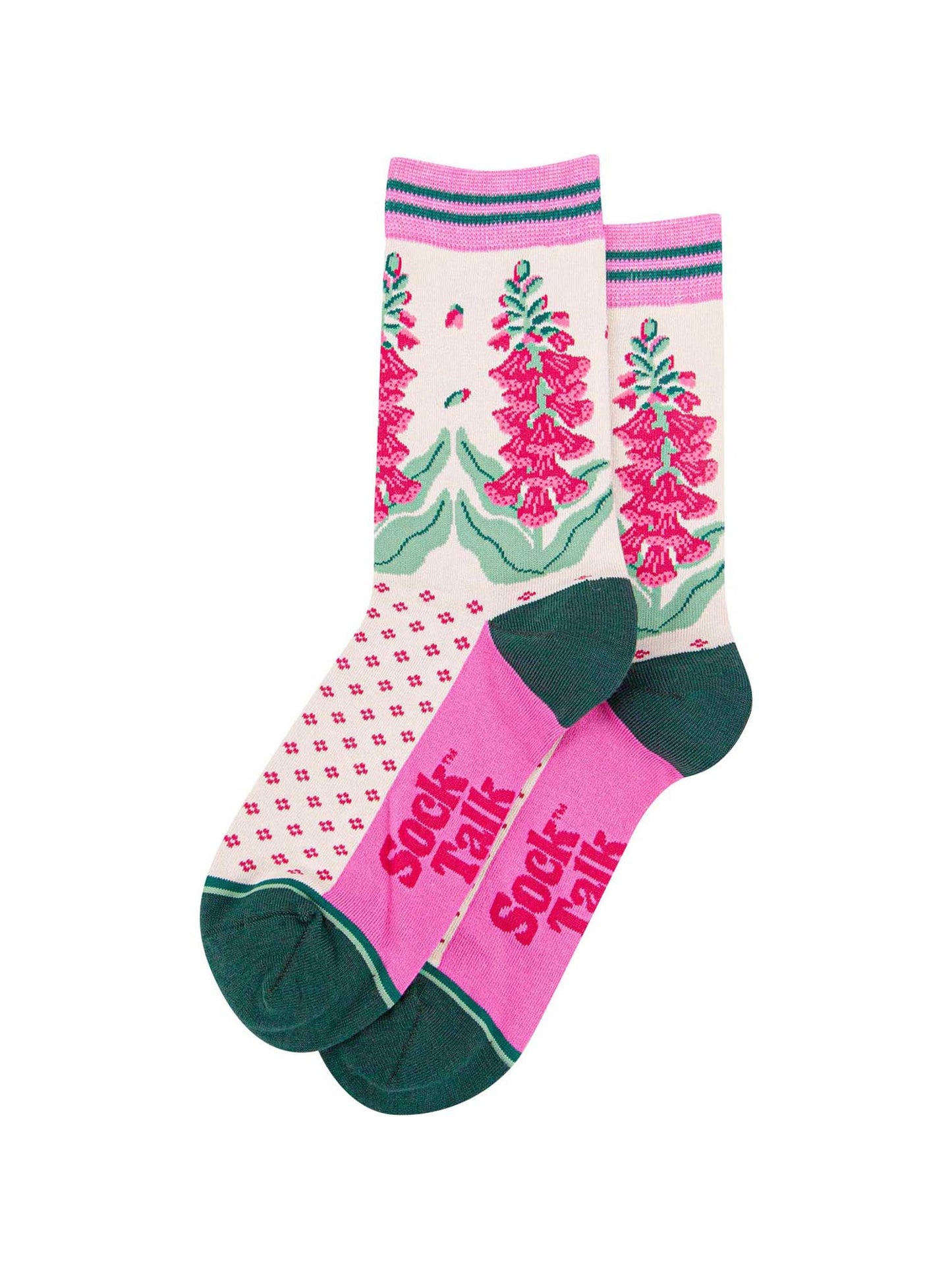 the pair of cream and pink foxglove socks laying flat one overlapping the other. showing clearly the cream background of the socks which is contrasted by a fuchsia pink dotted pattern. on the ankle of the socks there is a pattern of pink foxglove plants. the sock talk logo is fuchsia pink and  visible on the base of the sole.