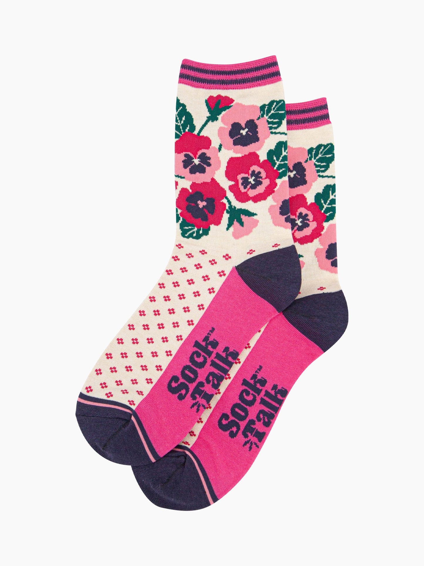 the pair of cream and pink pansy socks laying flat one overlapping the other. showing clearly the cream background of the socks which is contrasted by a fuchsia pink dotted pattern. on the ankle of the socks there is an arrangement of pink and fuchsia pansies. the sock talk logo is navy blue visible on the base of the sole