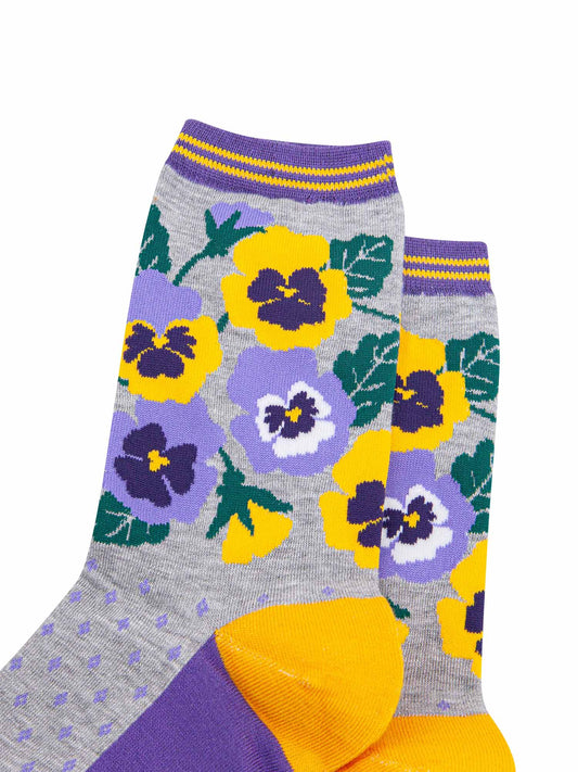 close up of the yellow and purple pansy flowers on the ankle of the bamboo socks