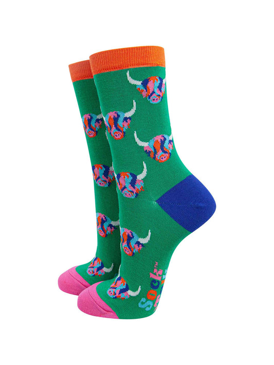mens green dress socks with an all over pattern of multicoloured highland cow faces