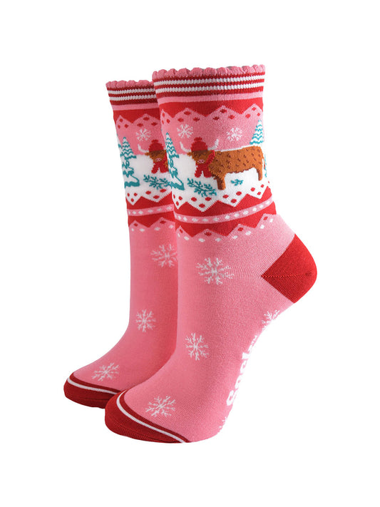 pink ankle socks with a red striped scalloped cuff with a highland cow standing in a snow covered field