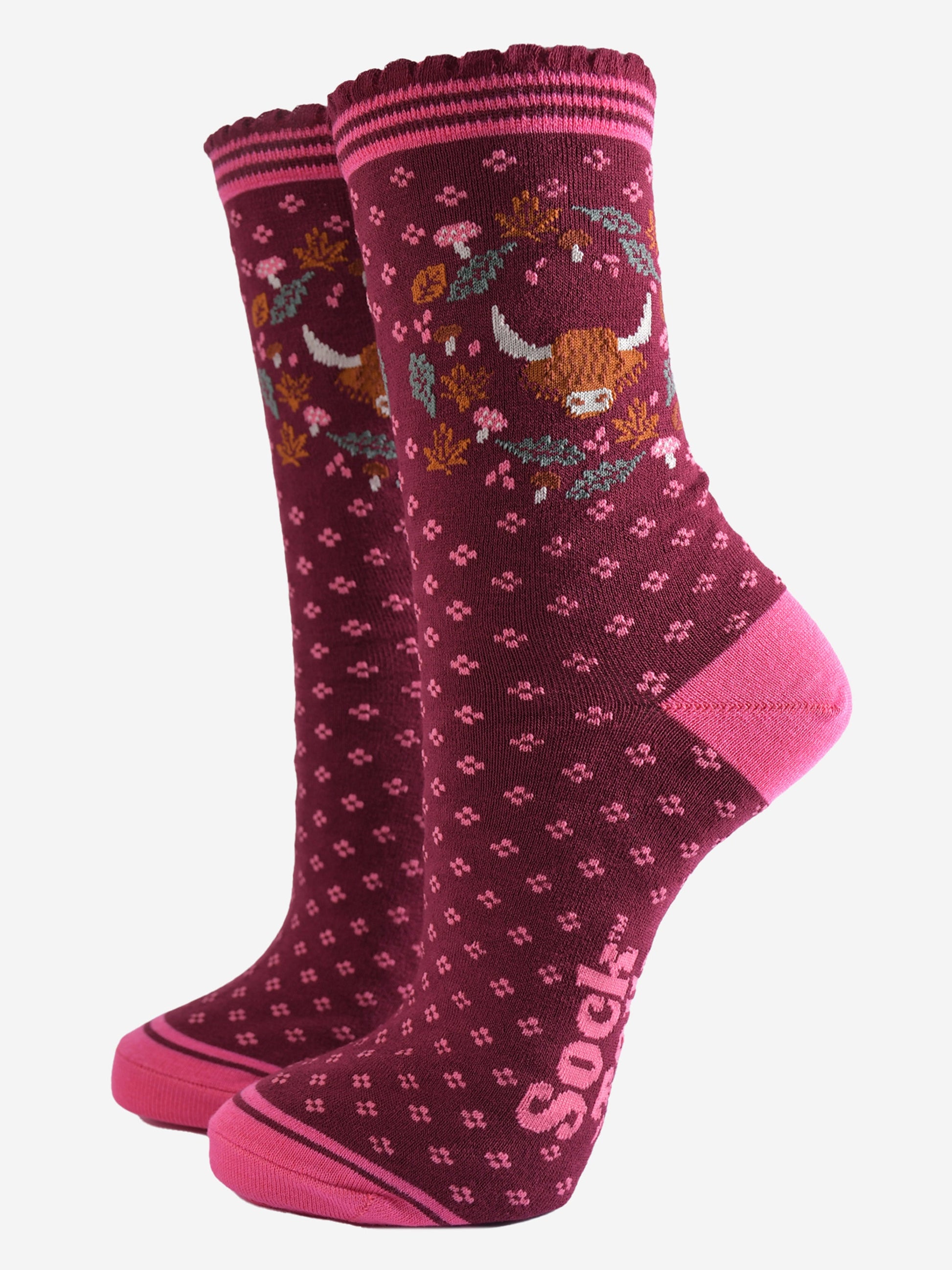 burgundy ankle socks with scalloped cuffs featuring a highland cow and a wreath featuring autumn leaves and woodland toadstools