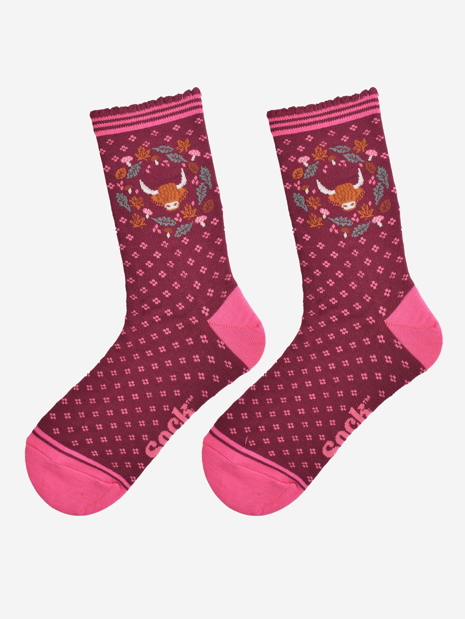highland cow wreath bamboo socks laying flat, showing burgundy socks with an all over pink floral pattern and a highland cow surrounded by autumn foliage on the ankles