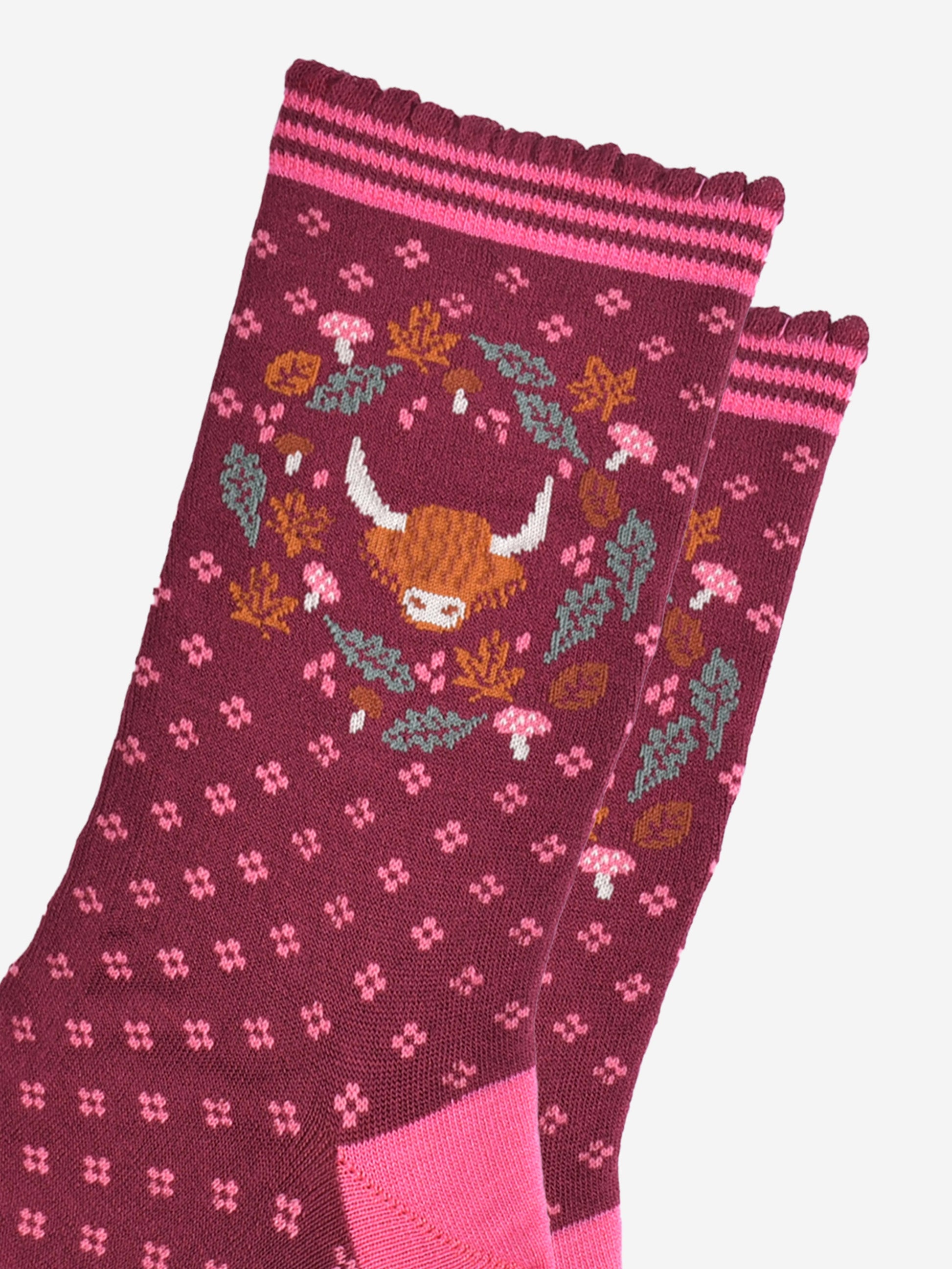 close up of the highland cow and wreath design which shows the head of a highland cow surrounded by autumn leaves and pink toadstools