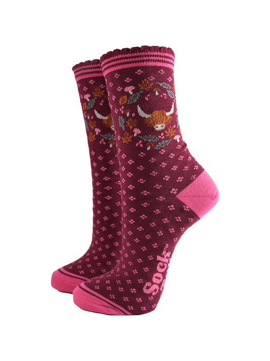 burgundy ankle socks with scalloped cuffs featuring a highland cow and a wreath featuring autumn leaves and woodland toadstools
