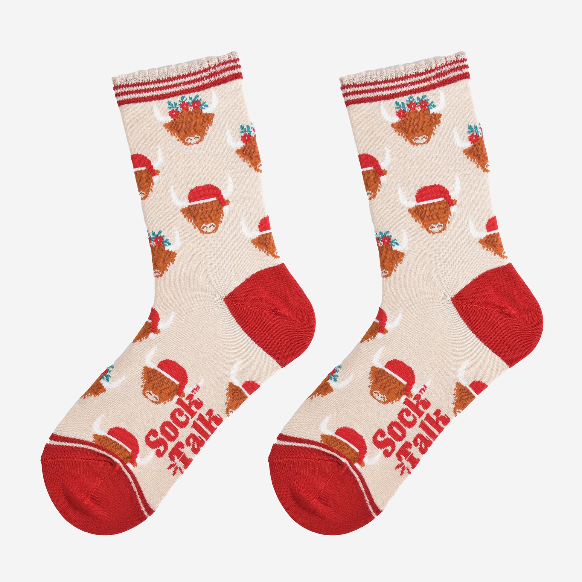 cream and red highland cow bamboo socks laying flat, showing the all over pattern of highland cows wearing santa hats and festive garlands