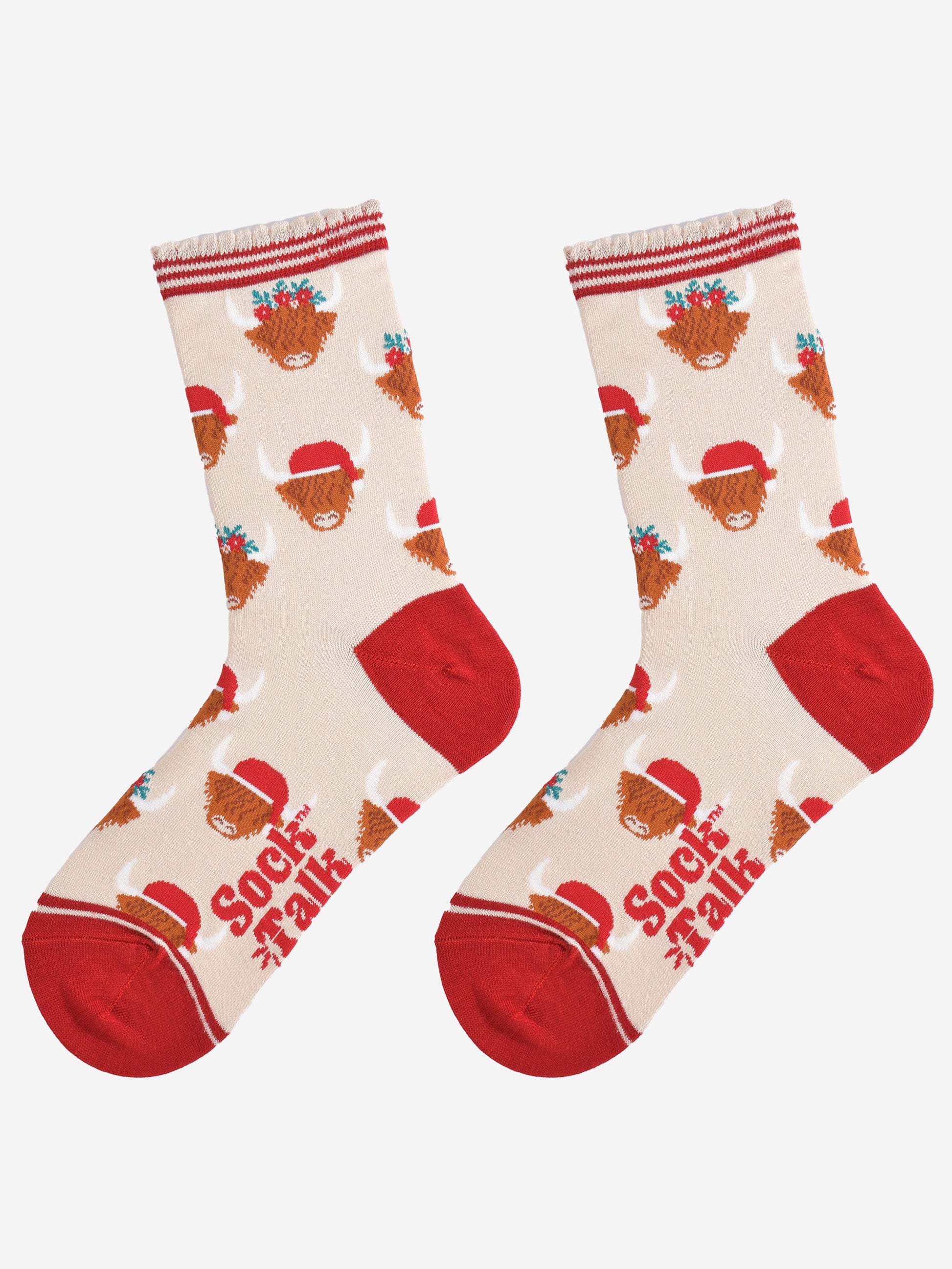 cream and red highland cow bamboo socks laying flat, showing the all over pattern of highland cows wearing santa hats and festive garlands