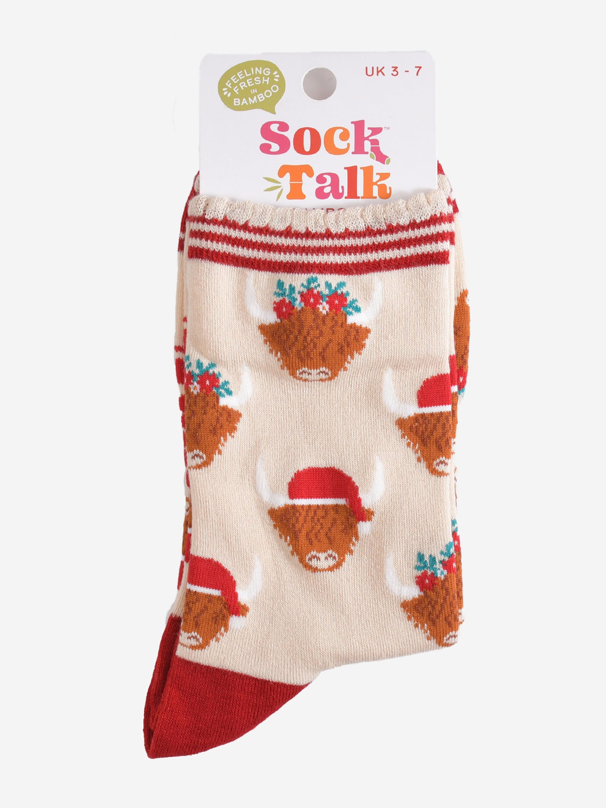 festive highland cow bamboo socks in their sock talk packaging, these socks are a uk size 3-7