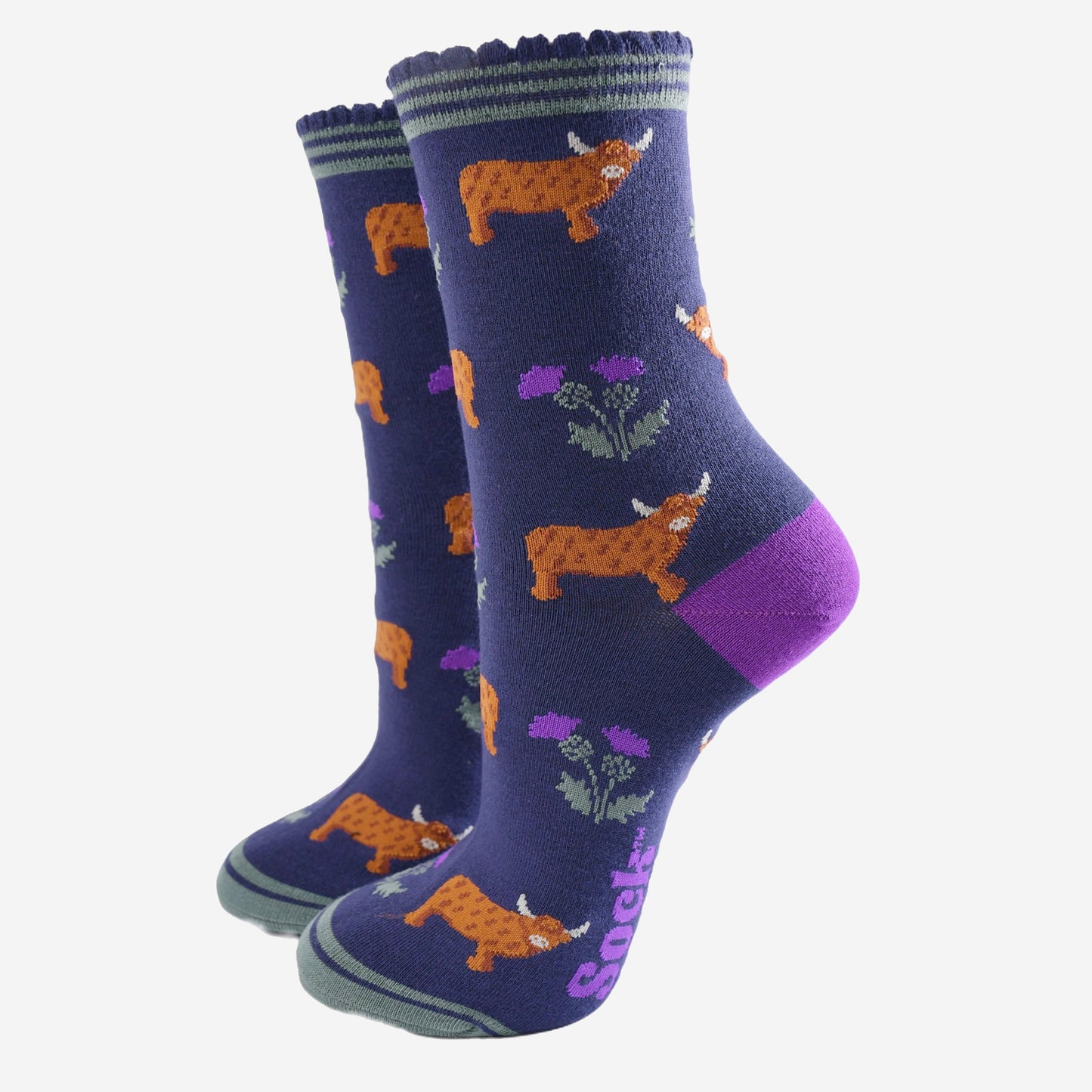 navy blue scalloped cuff ankle socks with a pattern of highland cows and thistles 