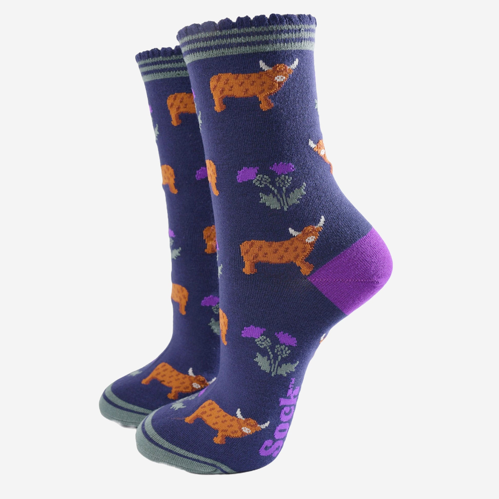 navy blue scalloped cuff ankle socks with a pattern of highland cows and thistles