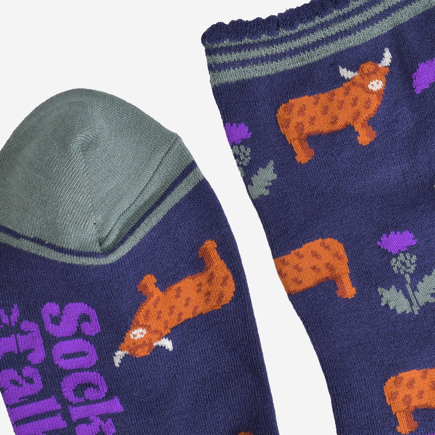 close up of the cuff and toe of the socks, the toe is green and the cuff had three green thin horizontal stripes and a scalloped edge