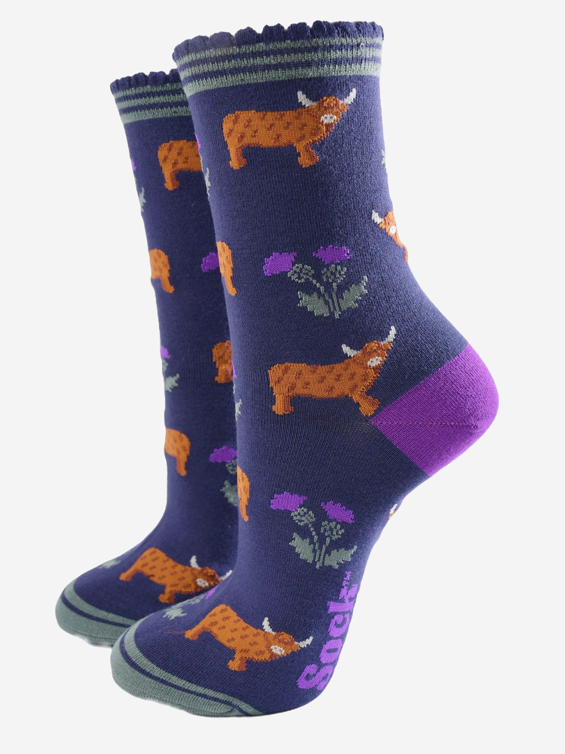 navy blue scalloped cuff ankle socks with a pattern of highland cows and thistles 
