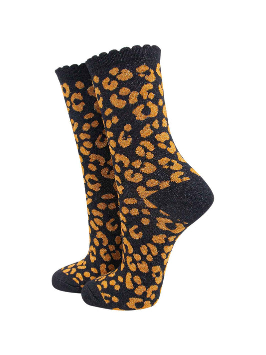 black ankle socks with an orange leopard print pattern, all over glitter sparkle and black scalloped cuff