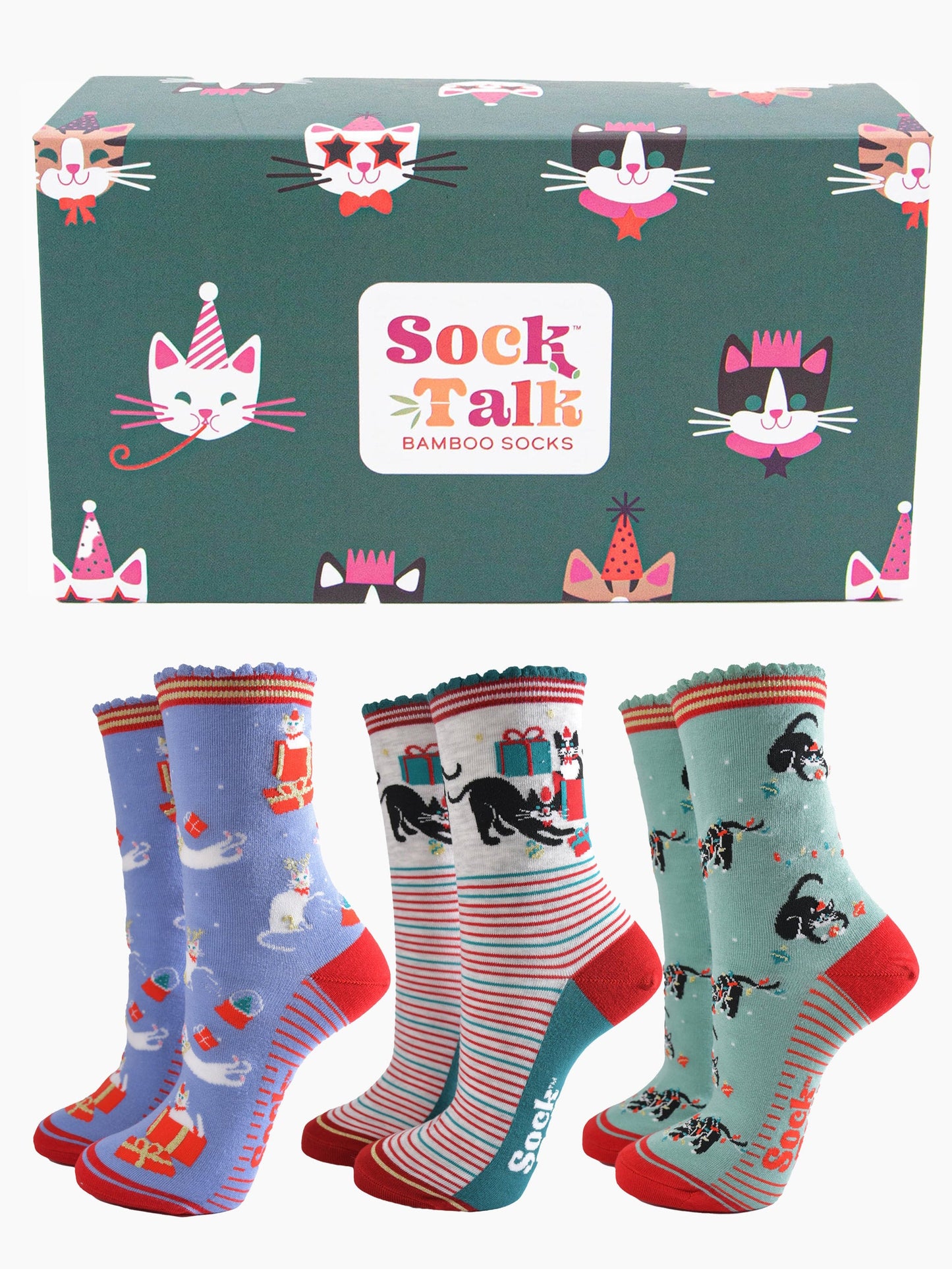 a green gift box adorned with cats wearing party hats and three pairs of festive inspired cat socks