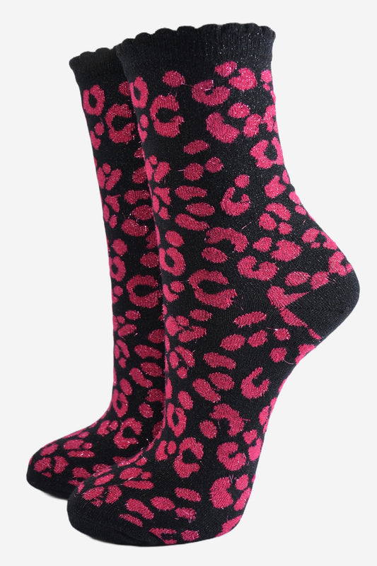 pink ankle socks with a black leopard print pattern, all over glitter sparkle and black scalloped cuff