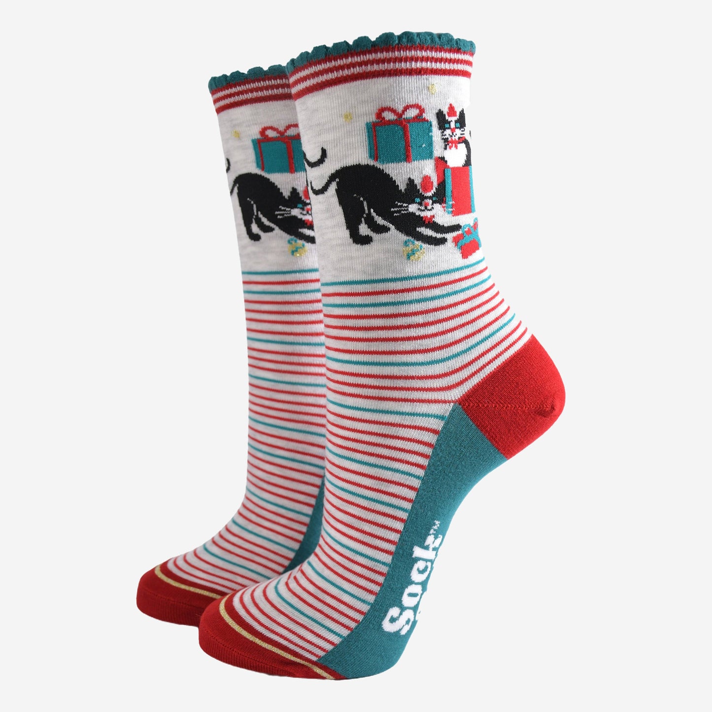 grey socks with green and red striped featuring black cats playing with wrapped christmas gifts