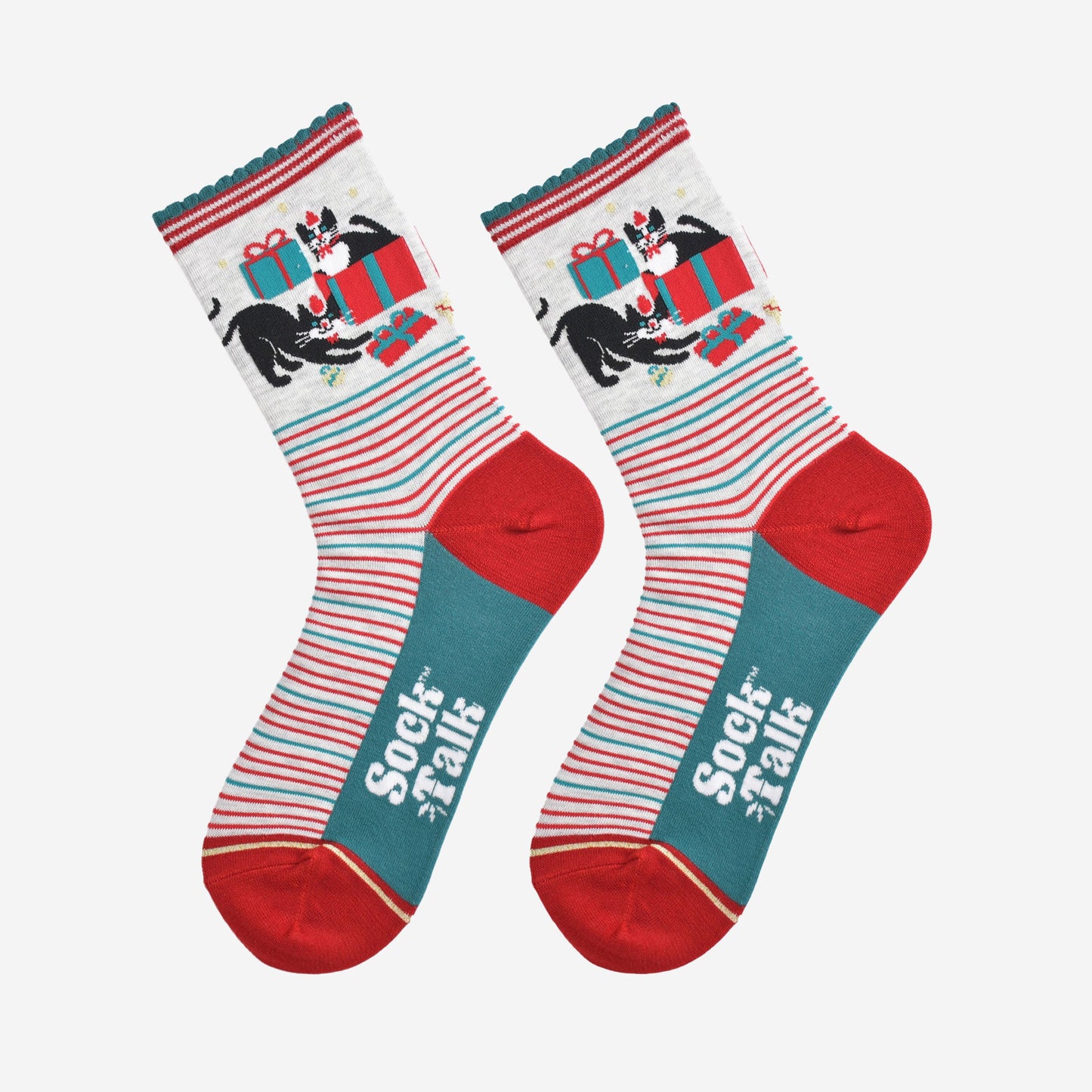 showing the socks laying flat, the black and white cats playing with christmas presents are prominent on the ankles and contrast the green and red striped patten on the feet of the socks