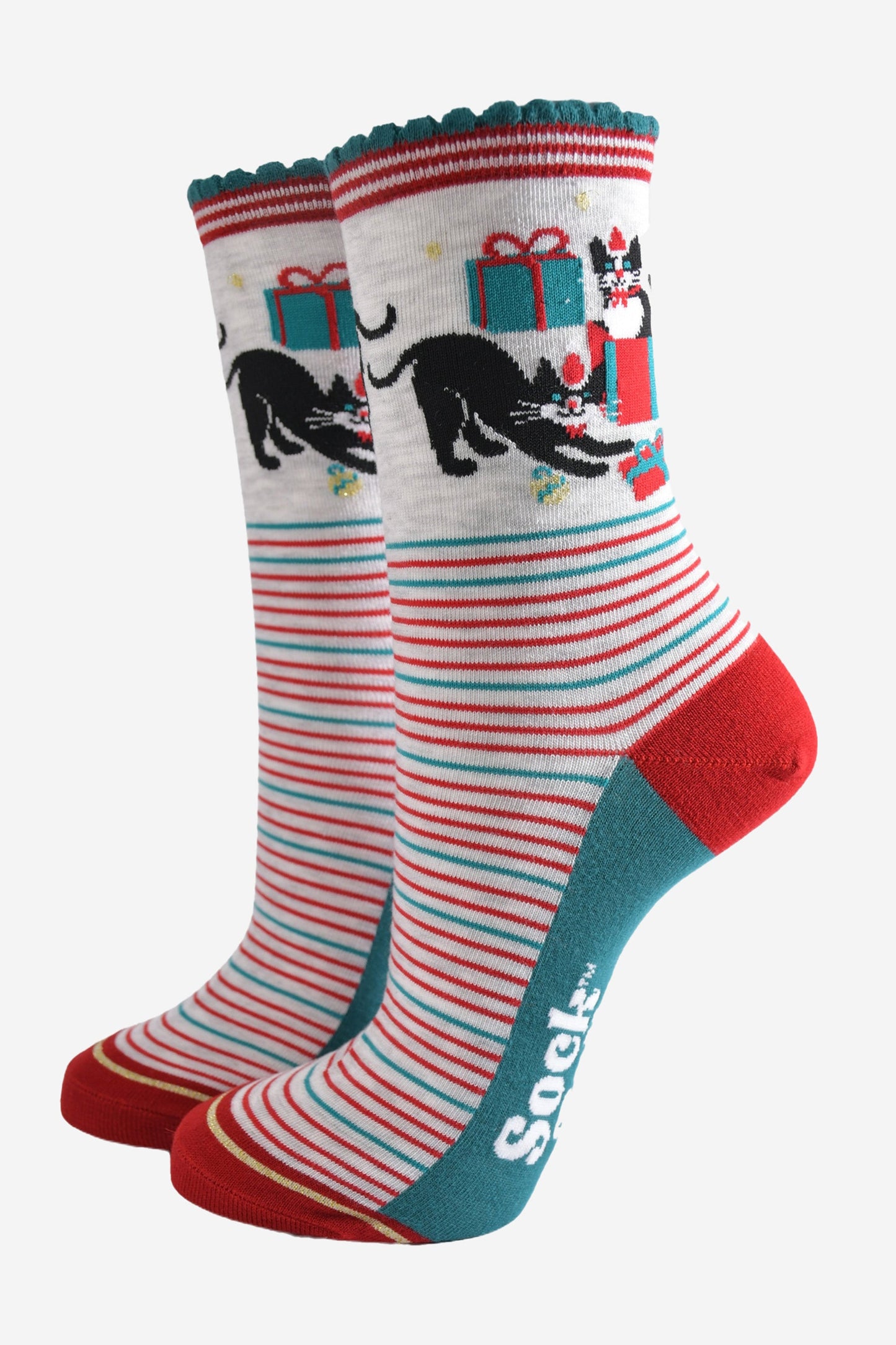 grey socks with green and red striped featuring black cats playing with wrapped christmas gifts