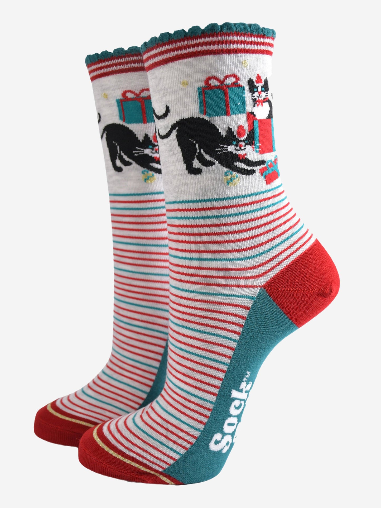 grey socks with green and red striped featuring black cats playing with wrapped christmas gifts