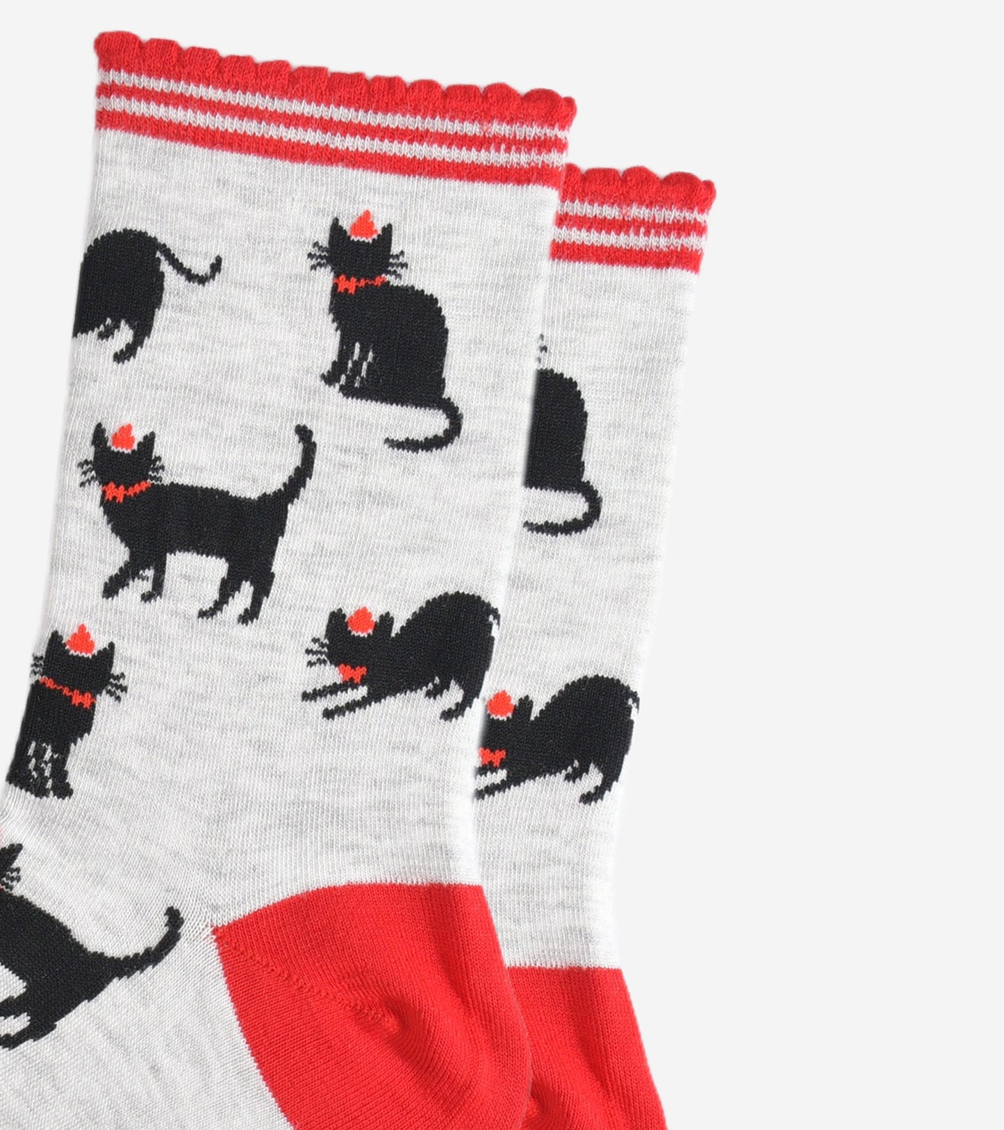 close up of the black cat design, the cats are wearing red party hats and bow ties