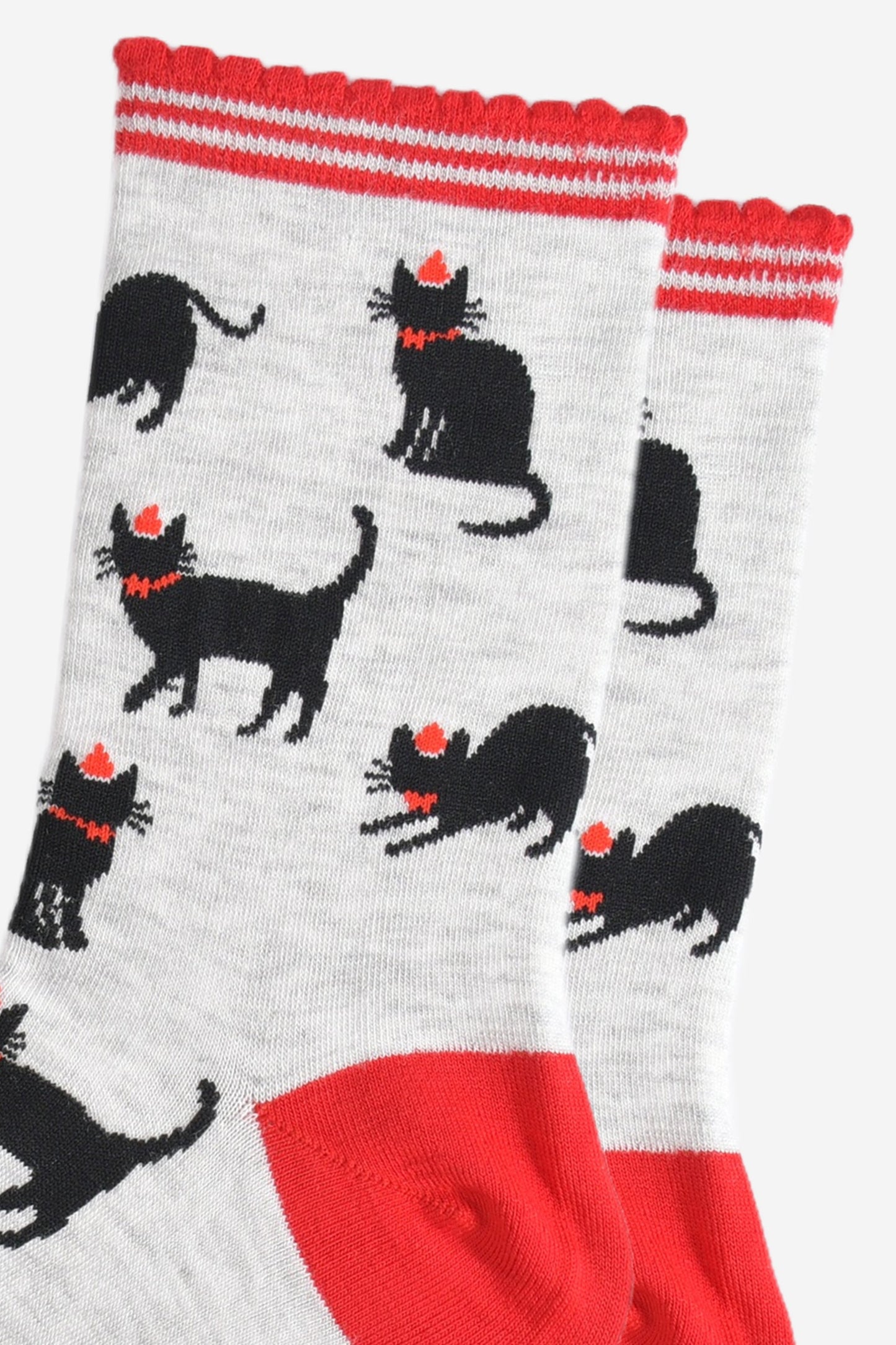 close up of the black cat design, the cats are wearing red party hats and bow ties