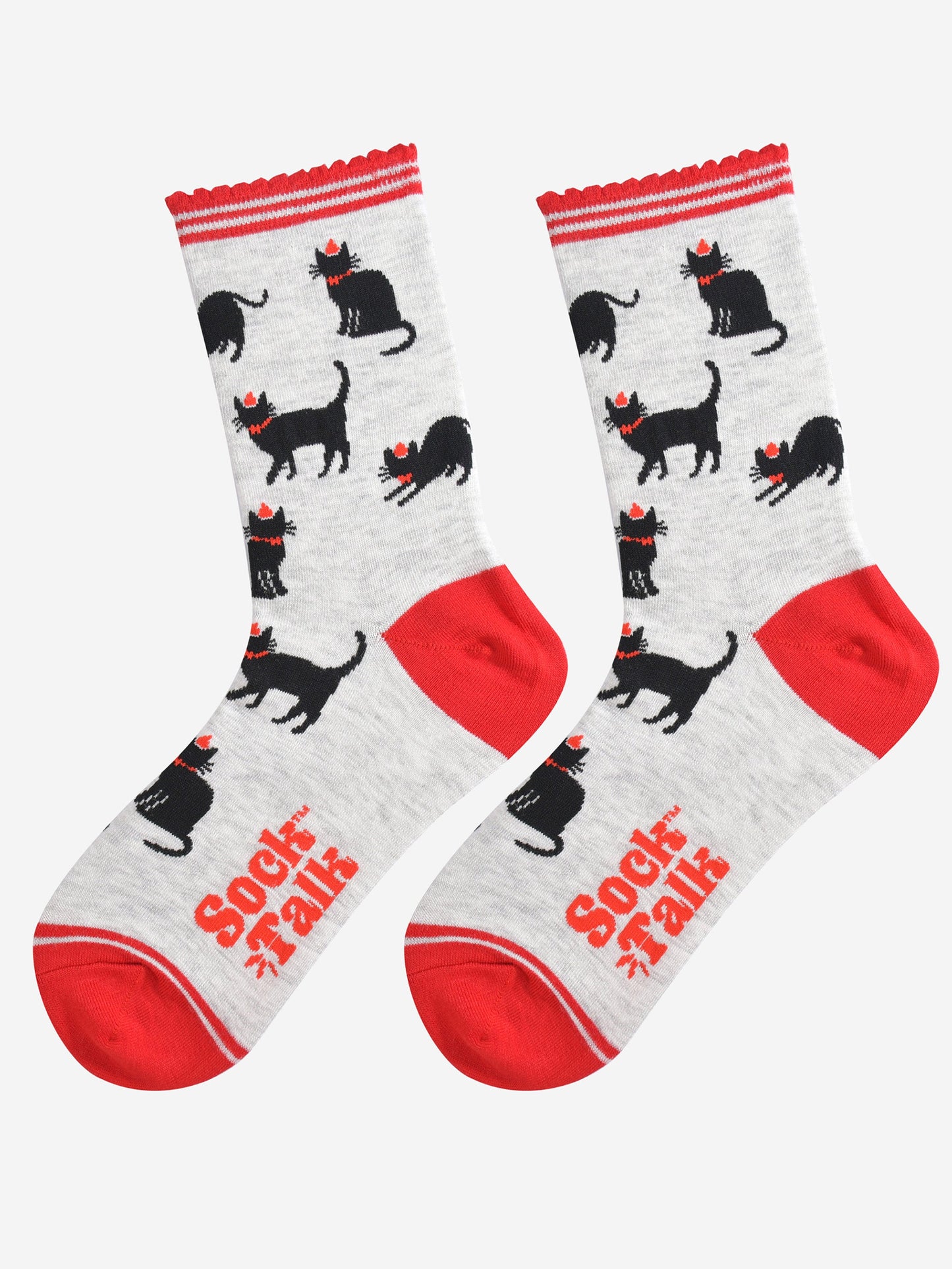 showing the black cat socks laying flat, highlighting the all over pattern of sitting, strutting and stretching cats, each wearing a red party hat and bow tie