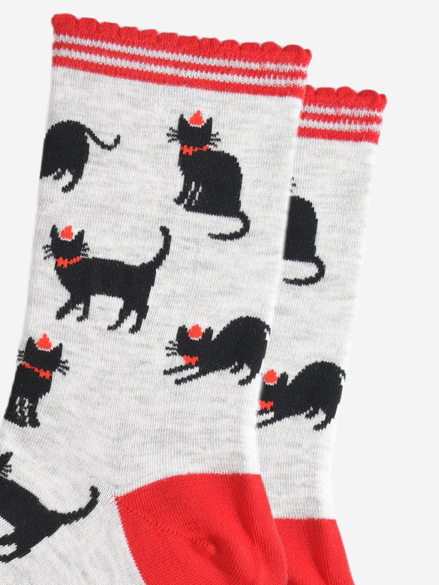 close up of the black cat design, the cats are wearing red party hats and bow ties