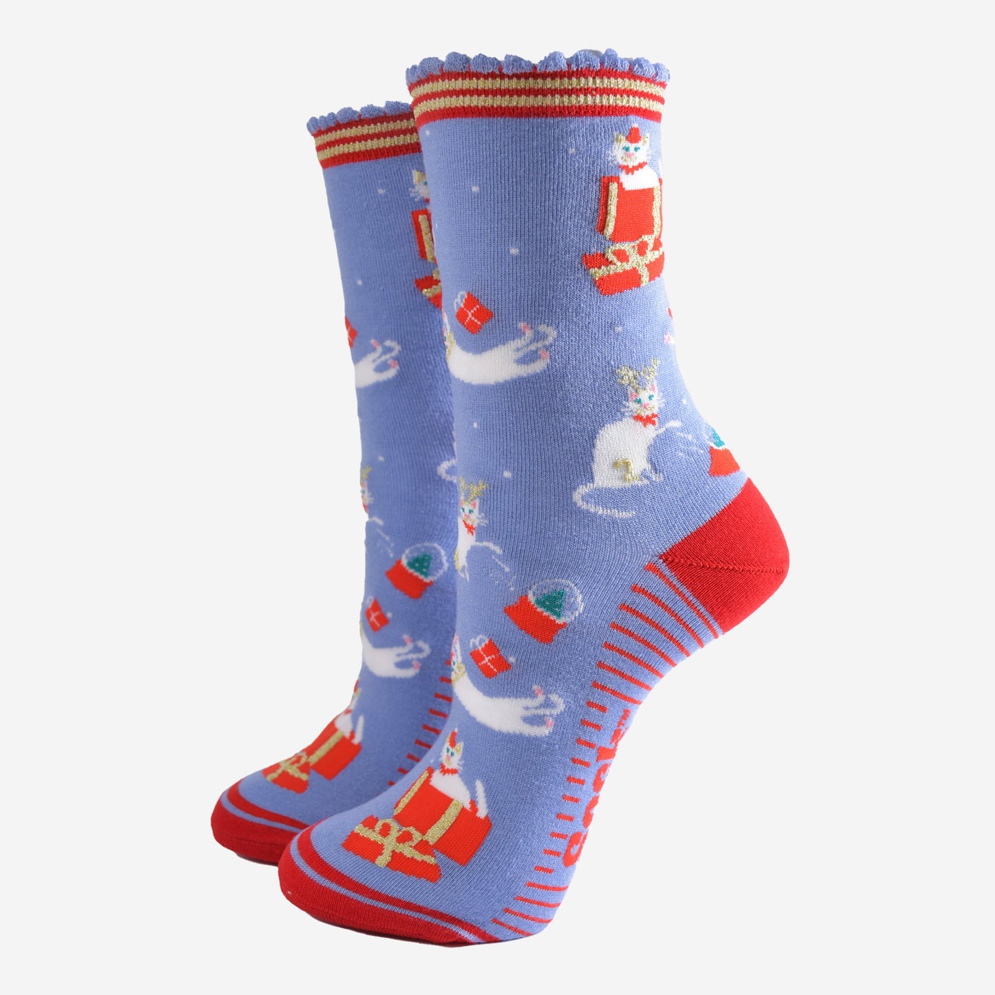 light blue socks with a contrasting red heel, toe and striped cuff and sole with a pattern of white cats playing with snow globes and christmas presents