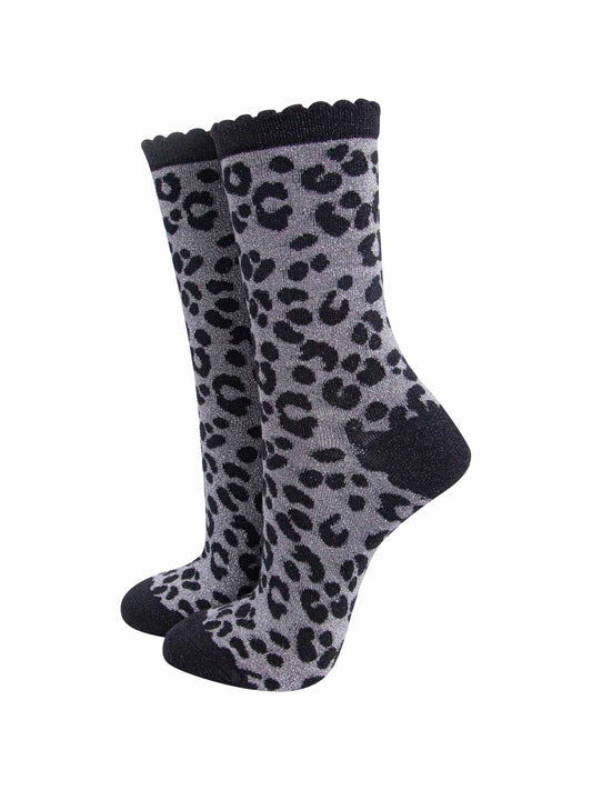 grey ankle socks with a black leopard print pattern, all over glitter sparkle and black scalloped cuff